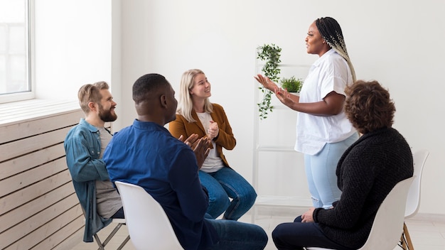 Medium shot people chatting at meeting