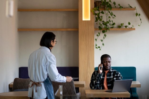 Medium shot people at coffee shop