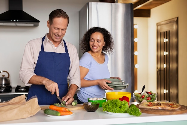 Medium shot people cooking together