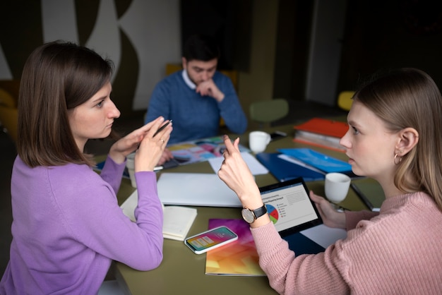 Medium shot people debating at office