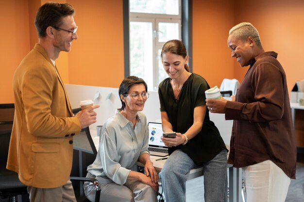 Medium shot people discussing at work