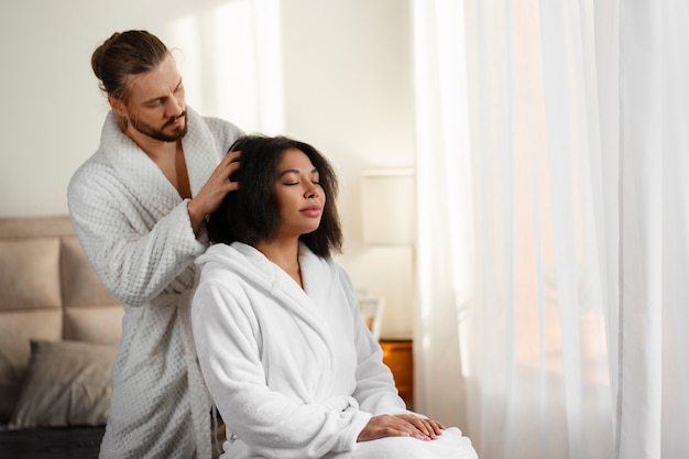 Medium shot people giving themselves scalp massage