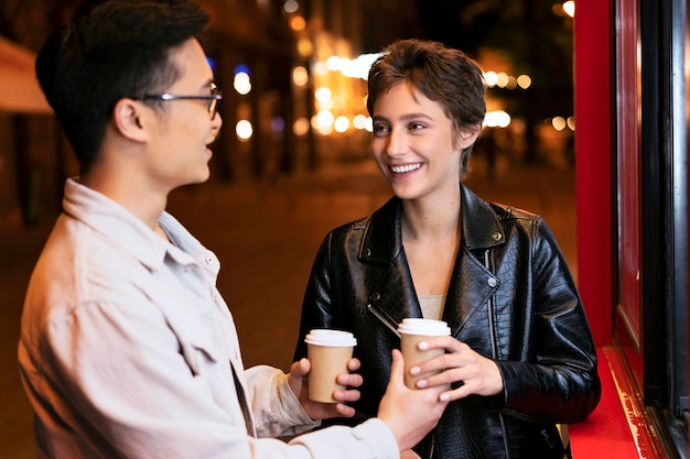 Medium shot people holding coffee cups