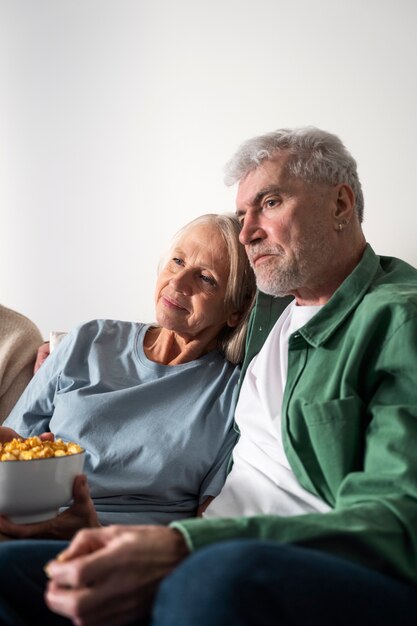 Medium shot people holding popcorn