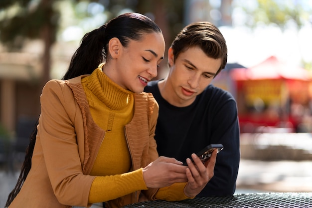 Medium shot people holding smartphone