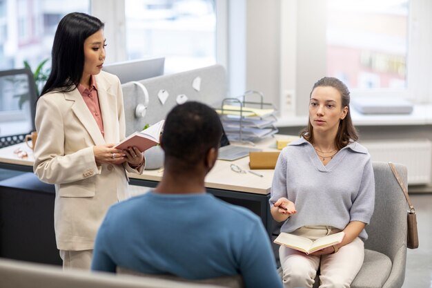 Medium shot people learning together at office