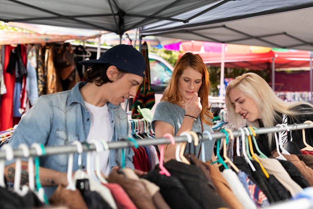 Medium shot people looking at clothes