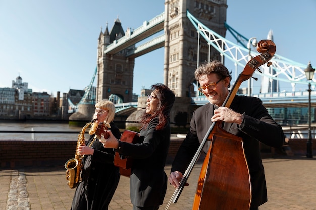 Medium shot people making music outdoors