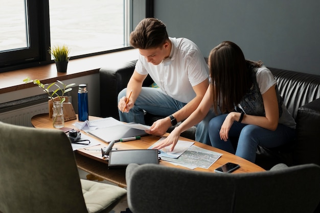 Medium shot people planning trip indoors