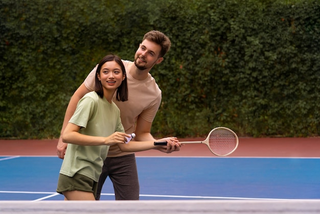 Free photo medium shot people playing badminton