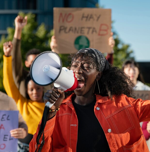 Medium shot people protesting with megaphone