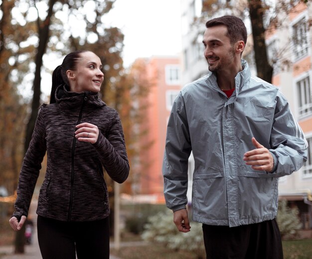 Medium shot people running outdoors