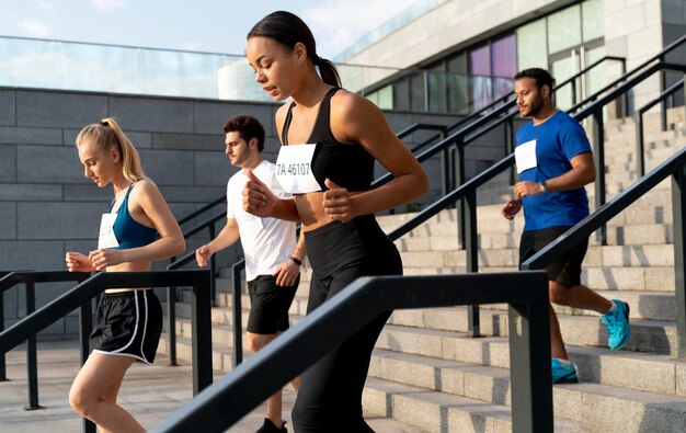 Medium shot people running together on stairs
