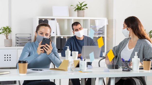 Medium shot people sitting at desk