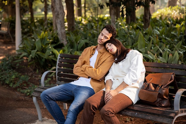 Medium shot people sleeping on bench