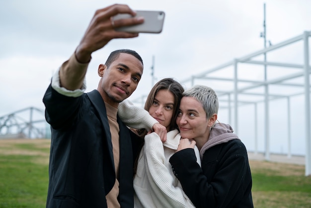 Free photo medium shot people taking selfie