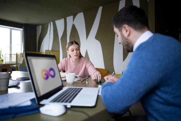 Medium shot people talking at office