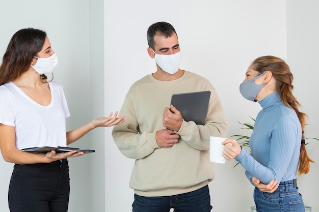 medium shot people talking at work