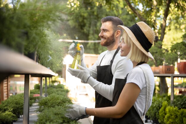 Medium shot people watering plants