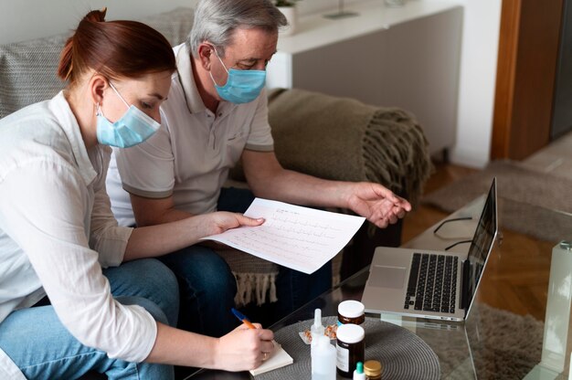 Medium shot people wearing masks indoors