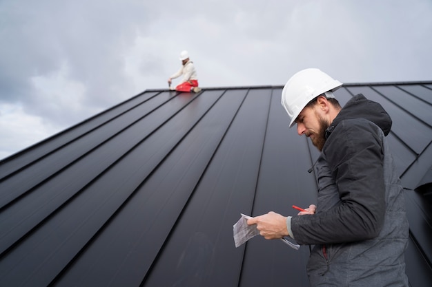 Roofing preparation asphalt shingles installing on house construction  wooden roof with bitumen spray and protection rope, safety kit. Roofing  construction. Stock Photo