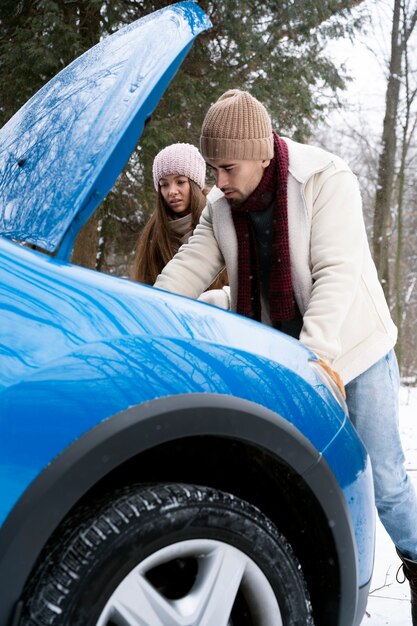 Medium shot people with blue car