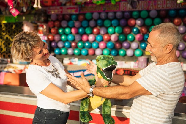 Medium shot people with dinosaur at theme park