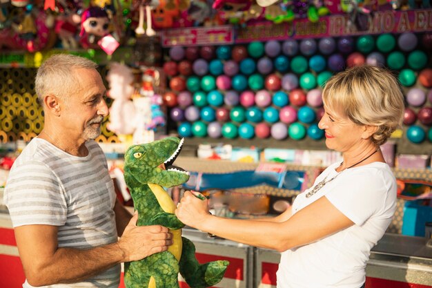 Medium shot people with dinosaur toy