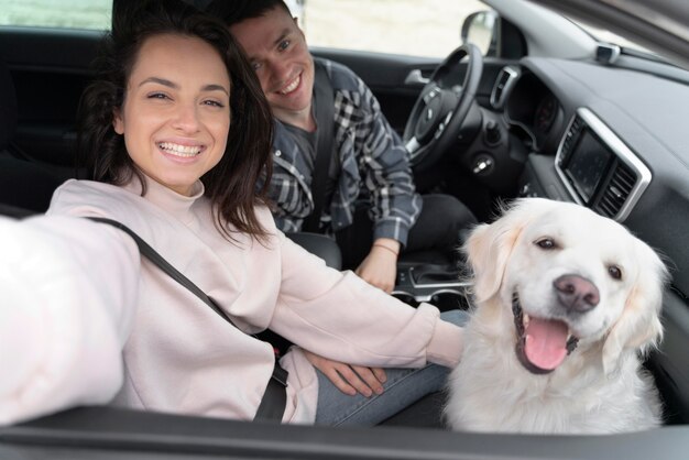 Medium shot people with dog in car