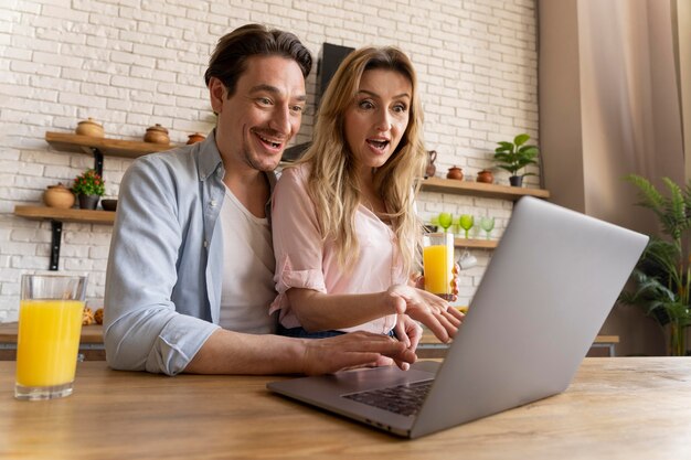 Medium shot people with laptop at table