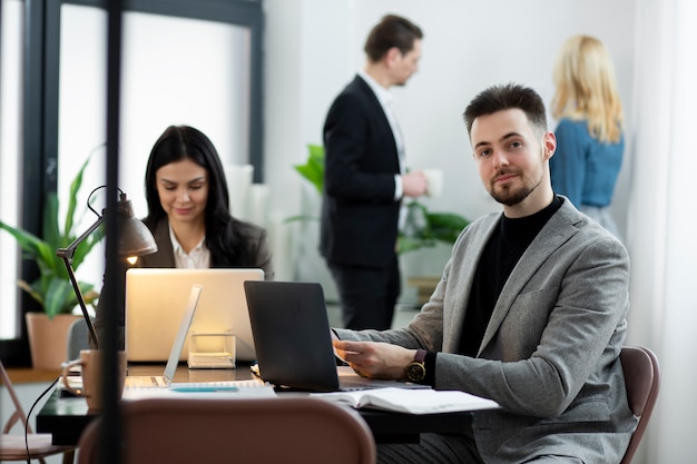 Medium shot people working at desk