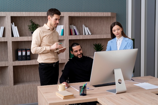 Medium shot people working with computer