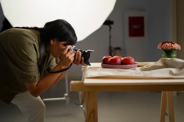 Free photo medium shot photographer taking fruit photos