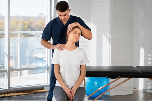 Medium shot physiotherapist helping patient