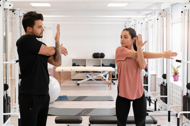 Medium shot physiotherapist helping patient