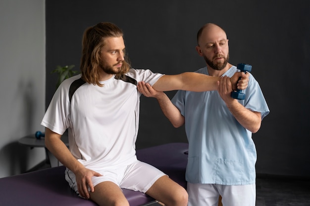 Medium shot physiotherapist helping patient