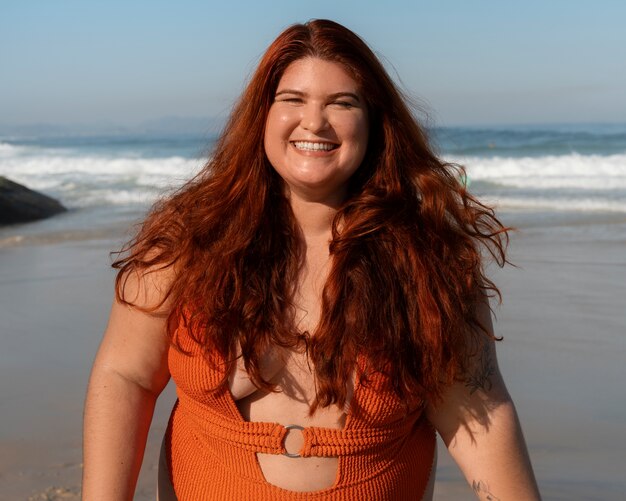 Medium shot plus-size woman posing at seaside