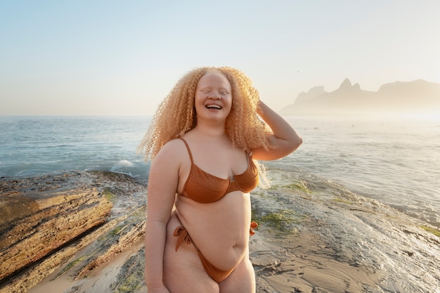 Medium shot plus-size woman posing at seaside