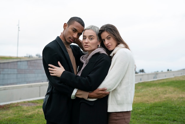 Free photo medium shot polyamorous people hugging