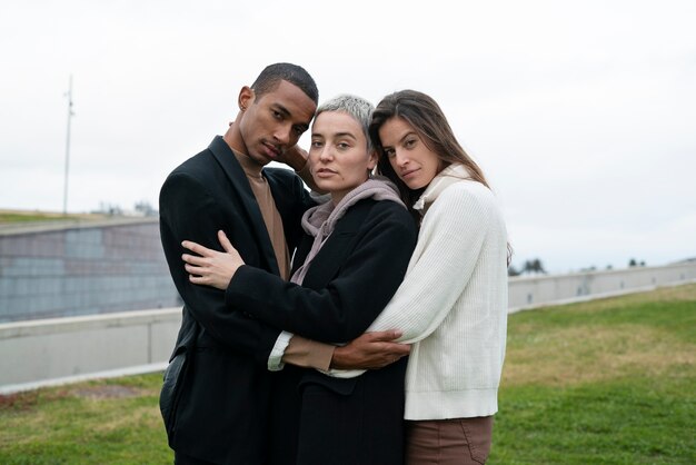 Medium shot polyamorous people hugging