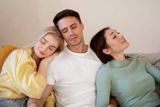 Medium shot polyamorous people sleeping