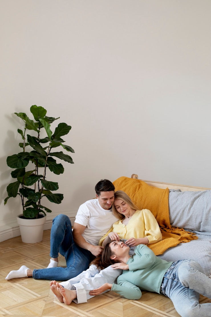 Free Photo medium shot polyamorous triad laying on floor