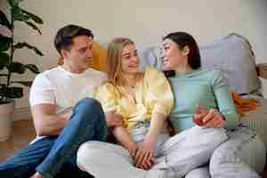 Free photo medium shot polyamorous triad sitting together