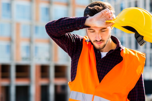 Free photo medium shot portrait of tired construction worker