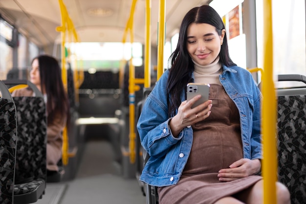 Medium shot pregnant woman sitting