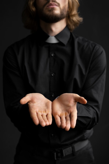 Medium shot priest showing his hands