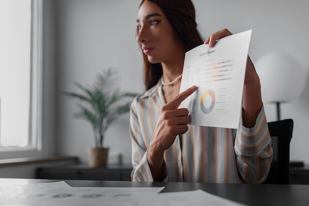 Medium shot queer model working in office