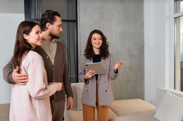Medium shot real estate agent showing house