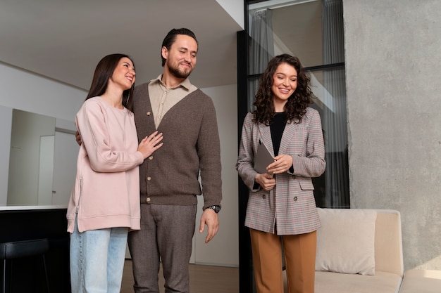 Medium shot real estate agent showing house