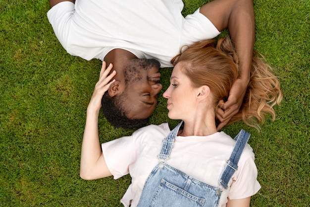 Medium shot romantic couple on grass